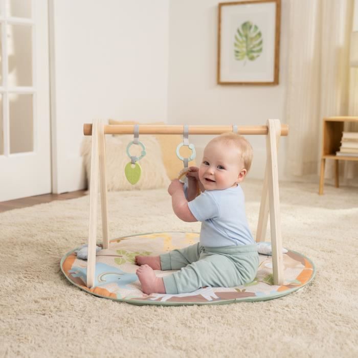 Alfombra de juego plegable para beb� INGENUITY WonderWood, redonda, con arco de madera, espejo y juguetes.